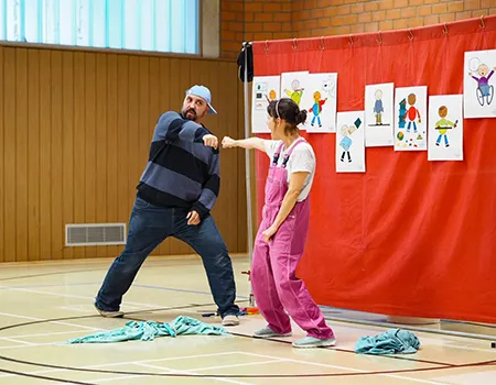 Zwei Theaterschauspieler zeigen eine Szene aus dem Theaterstück